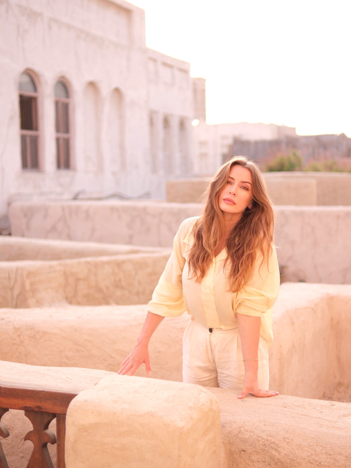 Sophia Constantine in pale yellow linen on a sunlit Dubai terrace